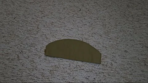Hand put a Russian military cap and an f1 grenade Stock Footage 221316934