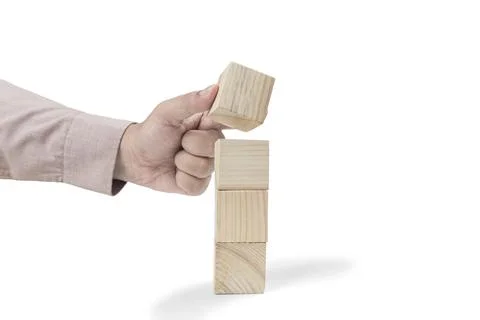 Hand put the stack of wooden block toy Stockfoto's