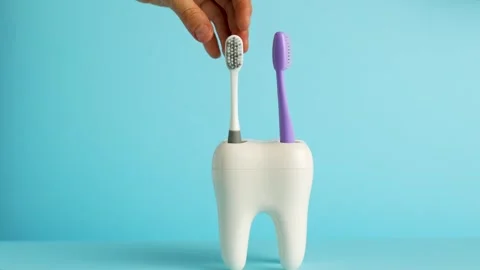 Hand put toothbrush from toothbrush holder tooth, close-up Stock Footage 253476232