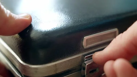 Hand put top secret envelope with classified files inside briefcase and locks it Stock Footage 304281745