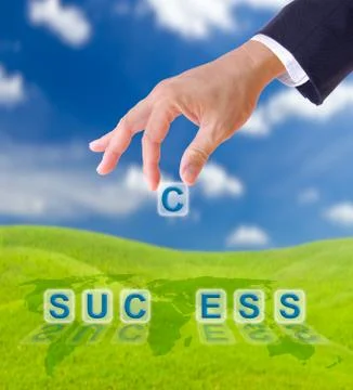 Hand puting letter c to  success word Stock Photos