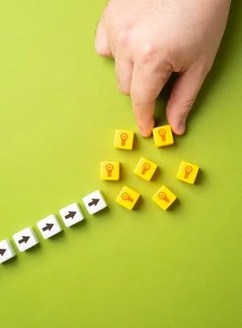 Hand puts blocks with light bulbs ideas. Concept of technological developme.. Stock Photos