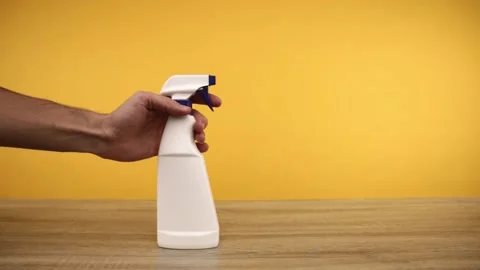 Hand puts a bottle with cleaning spray on table Stock-Footage 150402017