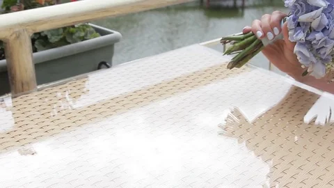 Hand puts the bouquet of flowers on the table Stock Footage 81653185