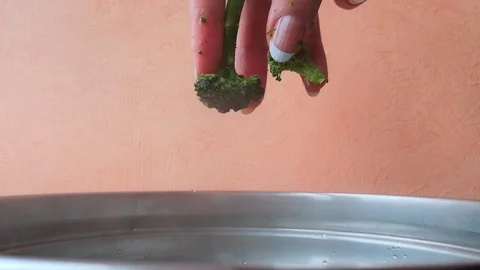 Hand puts broccoli to pan Stock Footage 103836058