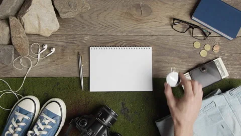 The hand puts the compass next to travel things Stock Footage 201869041
