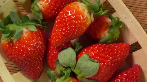 Hand puts delicious strawberries in a small basket Stock Footage 302109388
