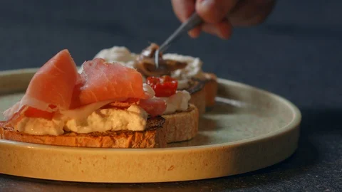 Hand puts a Dried tomatoes in olive oil typical from Italy Making a Sandwich 스톡 동영상 129577074