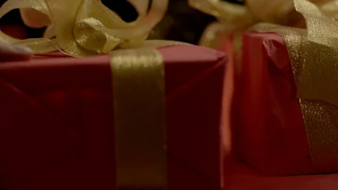 Hand puts a gift in a pile Stock Footage 77828153