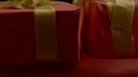 Hand puts a gift in a pile Stock Footage 77828175