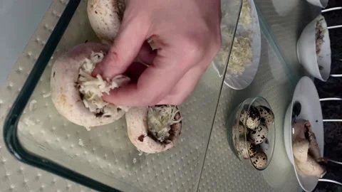 A hand puts grated cheese in the caps of champignons Stock Footage 167506565