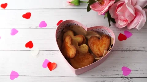 Hand puts heart cookie to box in blue box for valentine's day Stock Footage 146521358
