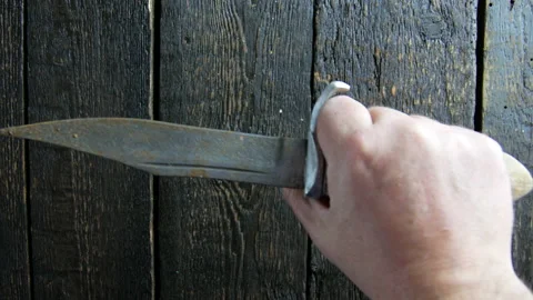 Hand puts knife on the wooden background Stock Footage 106937411