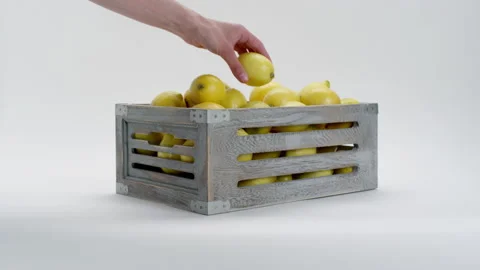 Hand puts lemon in to the basket Stock Footage 169815605