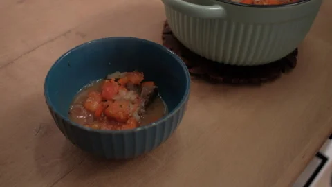 A hand puts meat and vegetables on a plate. Cooking healthy food at home Stock Footage 262433609