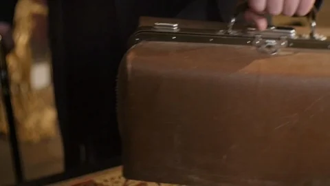 Hand Puts the Old Suitcase Stock Footage 87969598