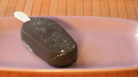 Hand puts an one chocolate ice cream Stock Footage 64739591