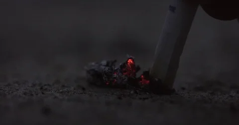 A hand puts out a cigarette on concrete Stock Footage 71784138