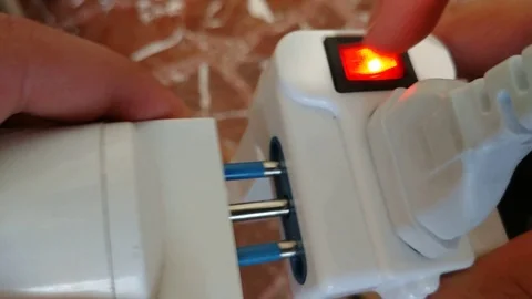 Hand Puts A Power Plug in power strip Stock Footage 92799218