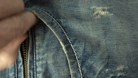 Hand puts a stack of dollar bills in jeans pocket in 4K. Stock Footage 140746857