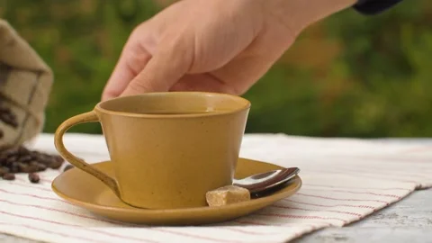 Hand puts sugar into a cup of coffee Stock Footage 141601589