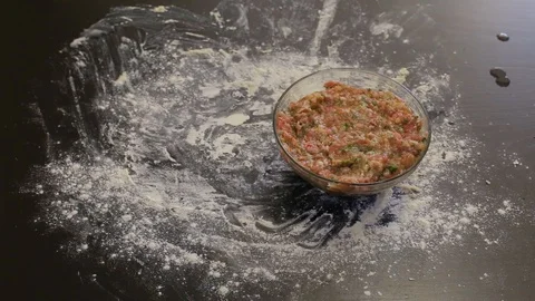 Hand puts on the table minced meat and dough for dumplings Video stock 97719619