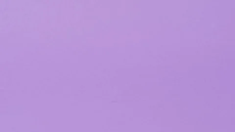 Hand puts a tablet on a purple background. Stockbeeldmateriaal 127695034