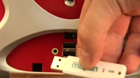 Hand puts USB stick into computer Stock Footage 924863
