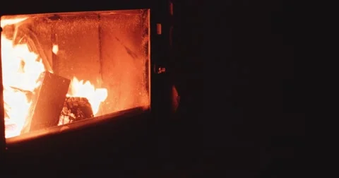 Hand puts Winter Boots to dry near Cozy Fireplace. 4K DCi SLOW MOTION 120 fps. Stock Footage 67217348