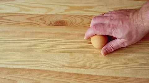 Hand puts on a wooden table two chicken eggs Stock Footage 70643347