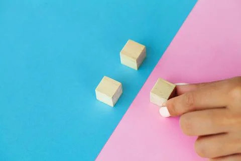 Hand putting and stacking blank wooden cubes on table with copy space for input Stock Photos