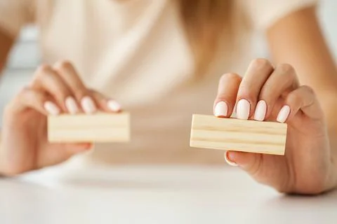 Hand putting and stacking blank wooden cubes on table with copy space for input Stock Photos