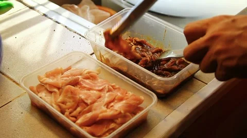 Hand putting bacon strips on a container with soy sauce seasoning. Stock Footage 337653952