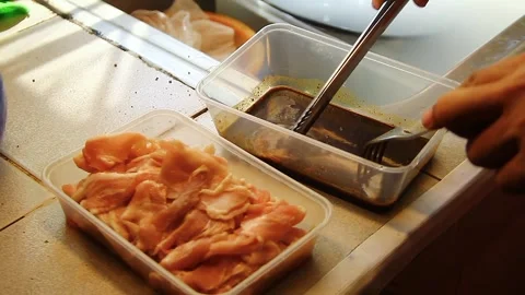 Hand putting bacon strips on a container with soy sauce seasoning. Stock Footage 337654010