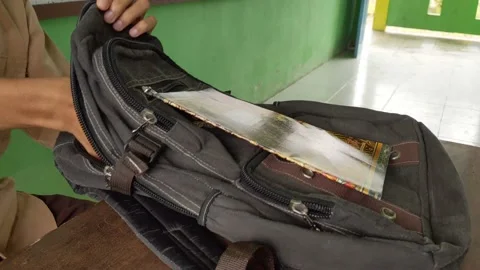 Hand putting a book in a bag Stock Footage 203195562