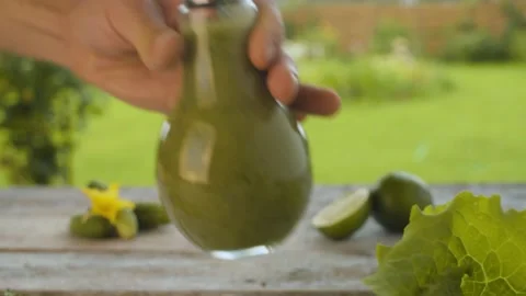 Hand putting bottle with smoothie on the table Stock Footage 137085192