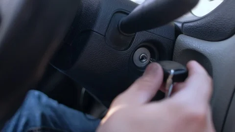 Hand putting car key to the keyhole, starting the car Video stock 114810855