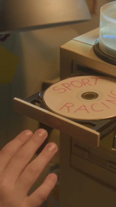 Hand Putting CD Disc in retro Pc Vertical Stock Footage 304857937