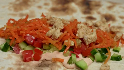 Hand putting chicken on flatbread pita. Stock Footage 262214860