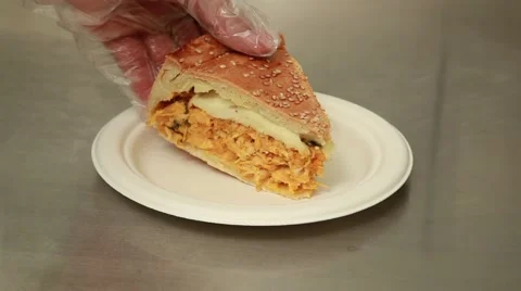 Hand putting a chicken pie slice over a dish Stock Footage 41452062