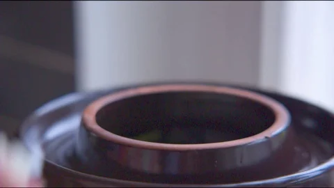 Hand putting chopped cabbage in a fermenting crock pot Stock Footage 76140012