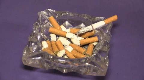 Hand putting cigarette out in ashtray Stock Footage 66814341