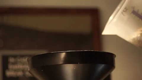 Hand putting coffee beans into the roasting machine Stock Footage 259794376