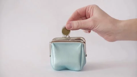 Hand putting a coin into blue leather coin purse Stock Footage 333834751