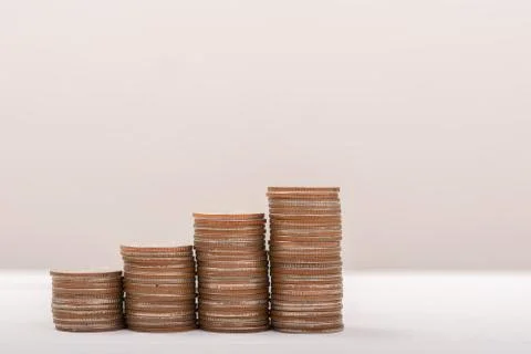 Hand putting coins on stack on table,Saving money concept or Business Growth  Stock Photos