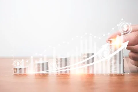 Hand putting coins stacking with virtual graph and increase arrow Stock Photos