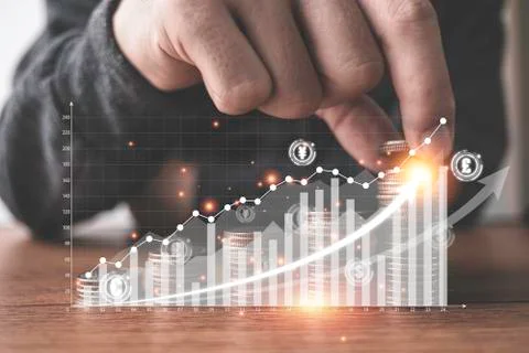 Hand putting coins stacking with virtual graph and increase arrow Stock Photos