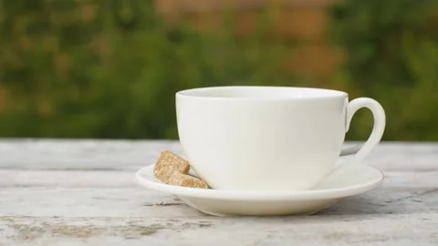 Hand putting cup of tea on the table Stock Footage 141601407