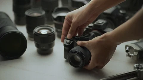 A hand putting down the camera between another camera and lens. Video stock 128406461