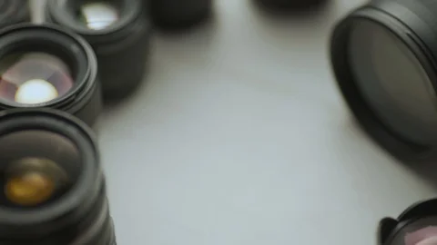 A hand putting down the lens of the camera between another lens. Video stock 128407593